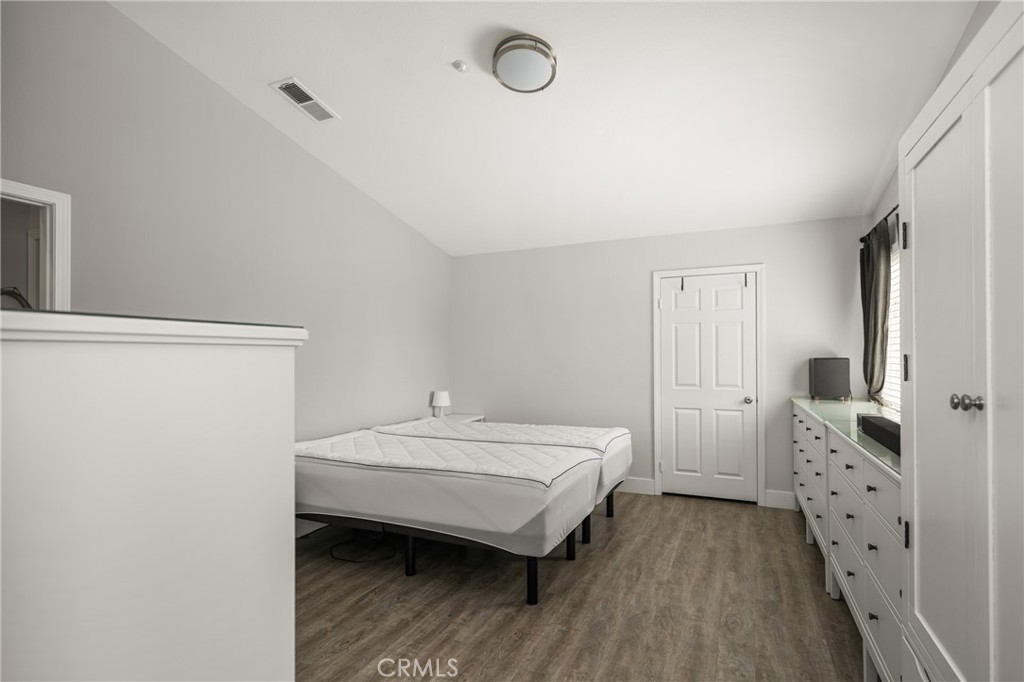 418 East Olive Avenue, Unit B Monrovia, CA 91016 - Photo 19 of 41 a bedroom with a bed and wooden floor