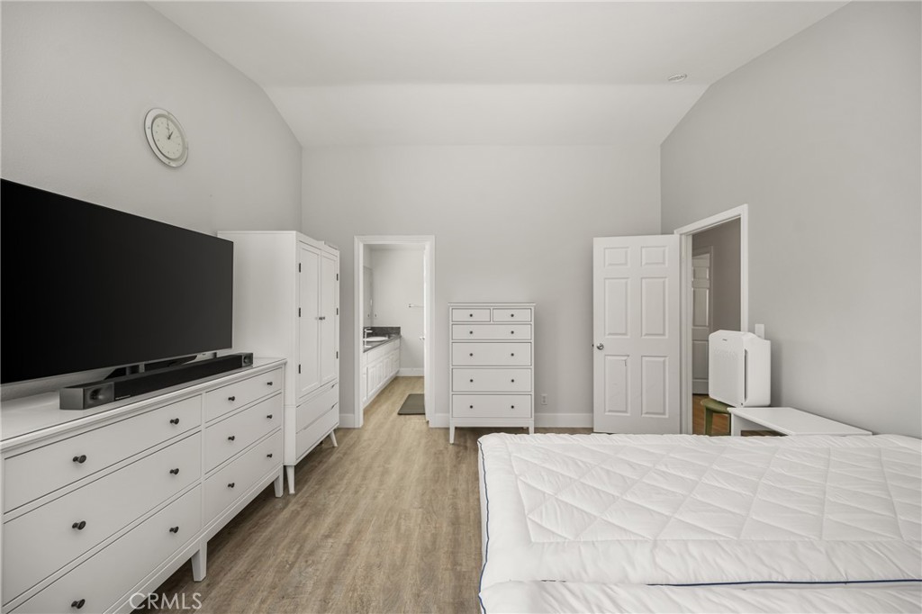 418 East Olive Avenue, Unit B Monrovia, CA 91016 - Photo 19 of 40 a bedroom with furniture and flat screen tv