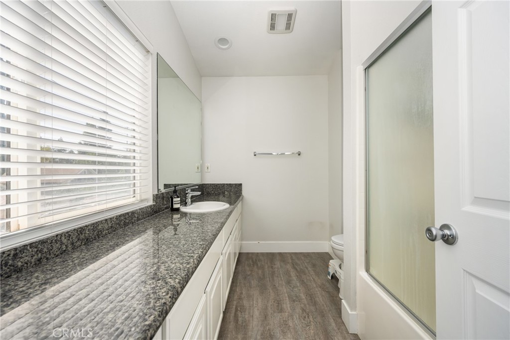 418 East Olive Avenue, Unit B Monrovia, CA 91016 - Photo 22 of 40 a bathroom with a granite countertop sink and a bathtub