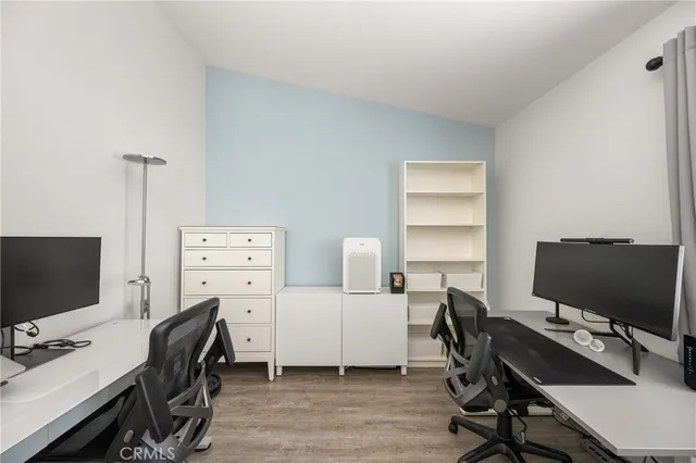 a view of a workspace with furniture and wooden floor