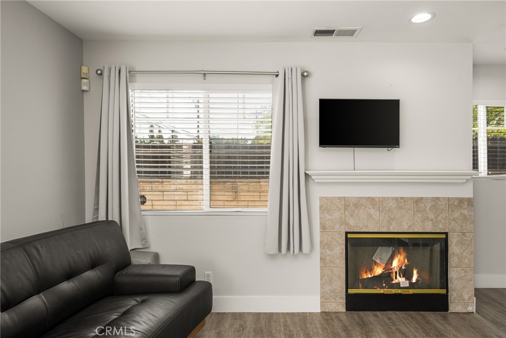 418 East Olive Avenue, Unit B Monrovia, CA 91016 - Photo 6 of 40 a living room with furniture a flat screen tv and a fireplace