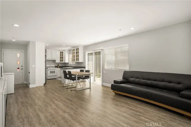 a living room with furniture and kitchen view