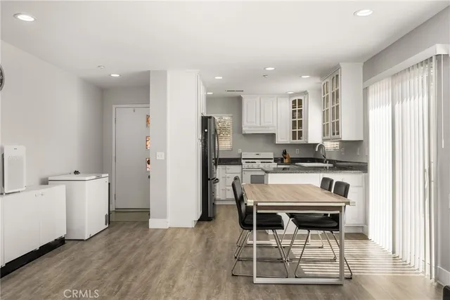 a kitchen with stainless steel appliances kitchen island granite countertop a refrigerator and a stove top oven