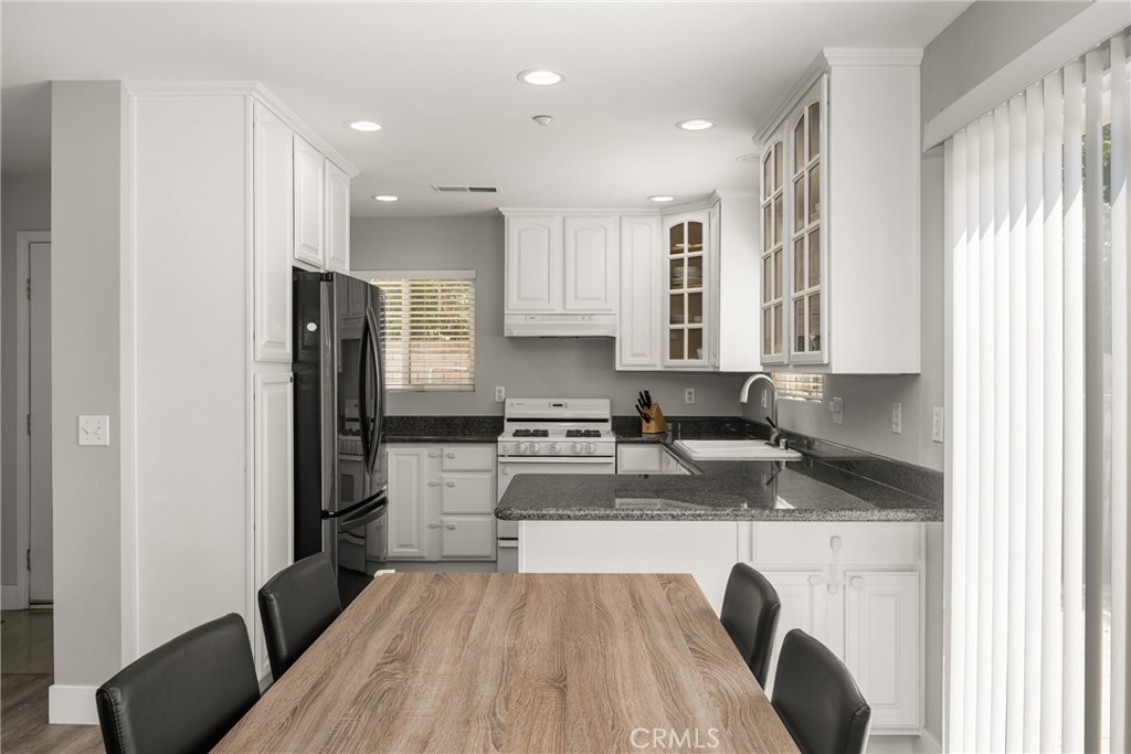 418 East Olive Avenue, Unit B Monrovia, CA 91016 - Photo 10 of 40 a kitchen with stainless steel appliances granite countertop a refrigerator and a stove top oven