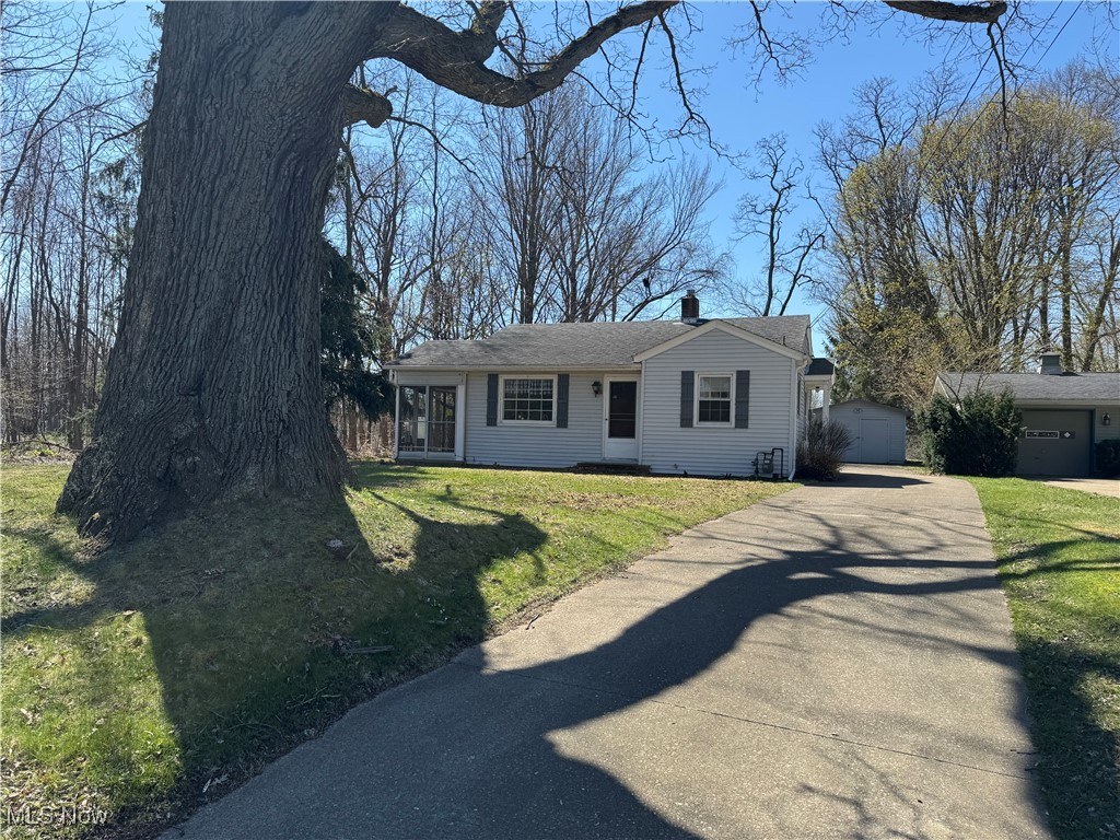 201 West Main Road Conneaut, OH 44030 - Photo 1 of 29 Ranch-style house featuring a garage, driveway, an outbuilding, and a front yard