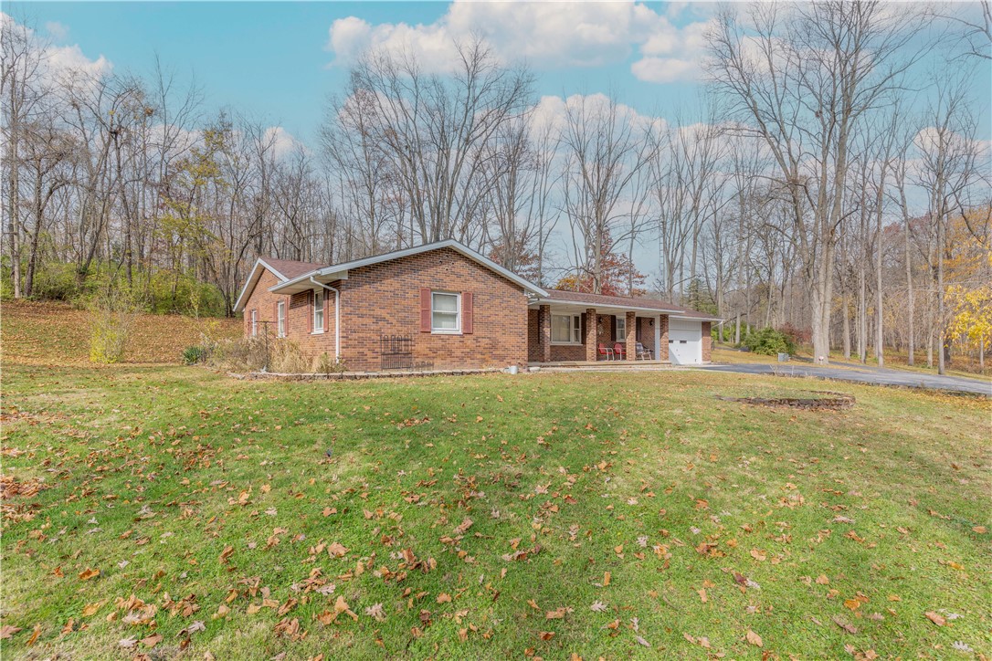 18333 Lefevre Number 2 Road Sidney, OH 45365 - Photo 6 of 25 This classic brick residence is nestled on a spacious lot surrounded by mature trees.