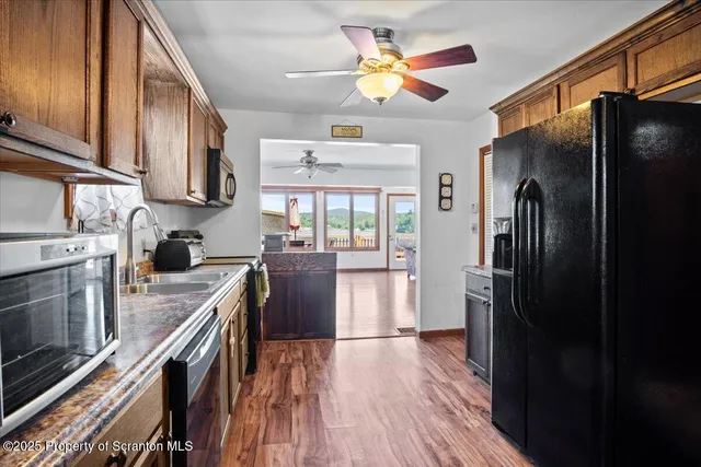 a kitchen with stainless steel appliances granite countertop a refrigerator a stove top oven a sink and dishwasher