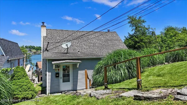 a view of a house with a tree