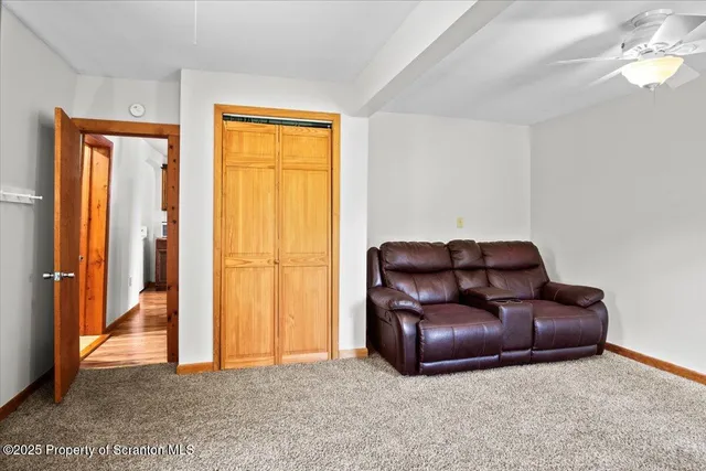 a living room with a couch and a dresser with wooden floor