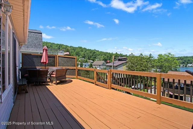 a roof deck with a table and chairs