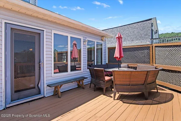 a balcony with wooden floor and city view