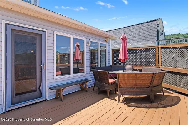 a balcony with wooden floor and city view