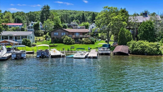an aerial view of a houses with a lake view