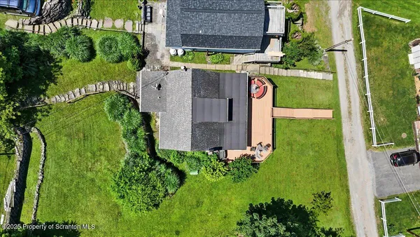 an aerial view of a house with a yard and potted plants