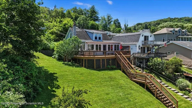 an aerial view of a house with swimming pool garden and patio