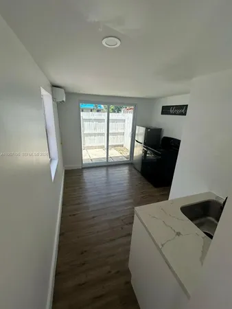 a view of kitchen and wooden floor