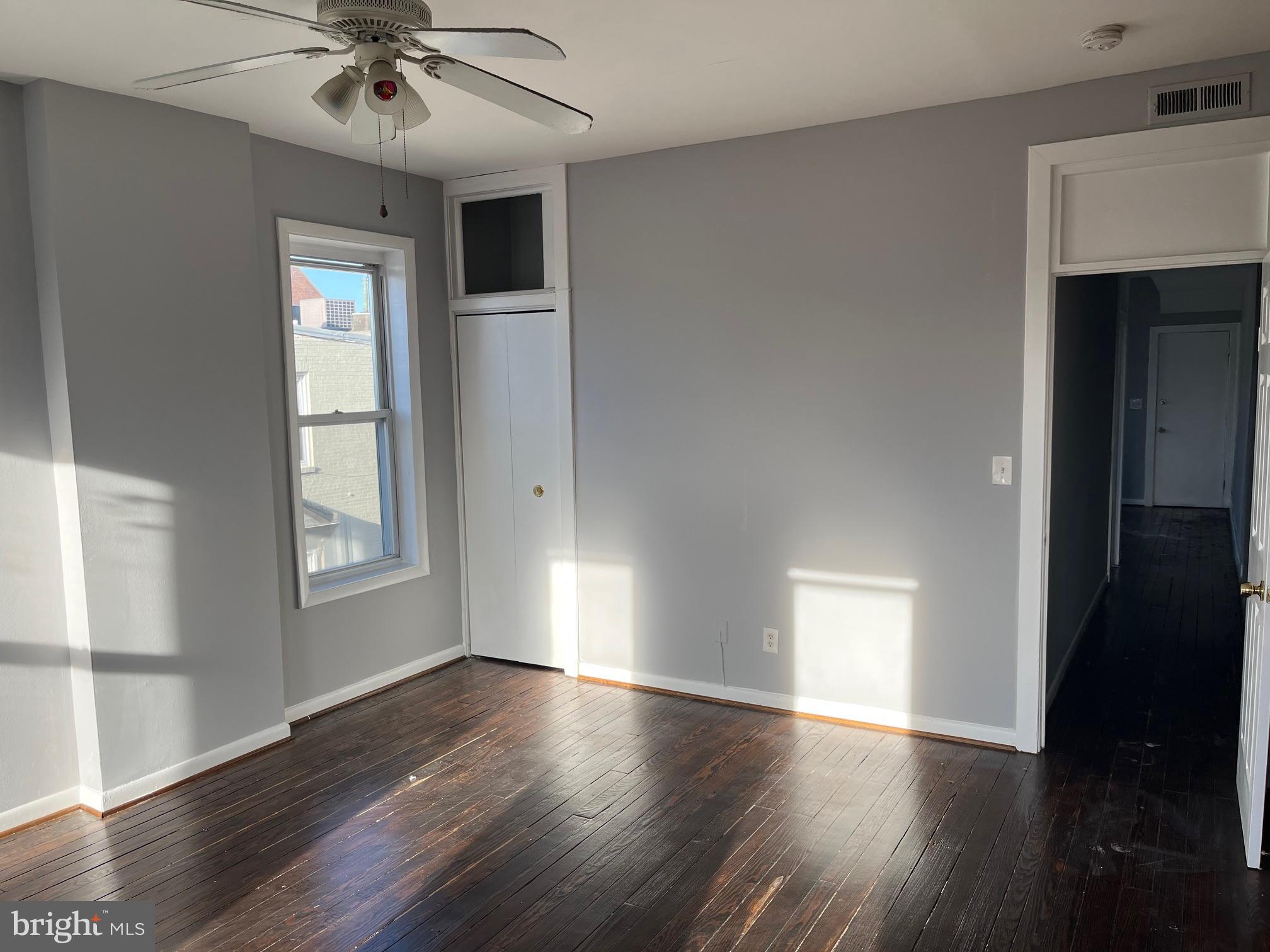 1001 Light Street, Unit 3 Baltimore, MD 21230 - Photo 5 of 14 a view of an empty room with wooden floor and a window