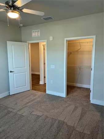 an empty room with closet and a bathroom