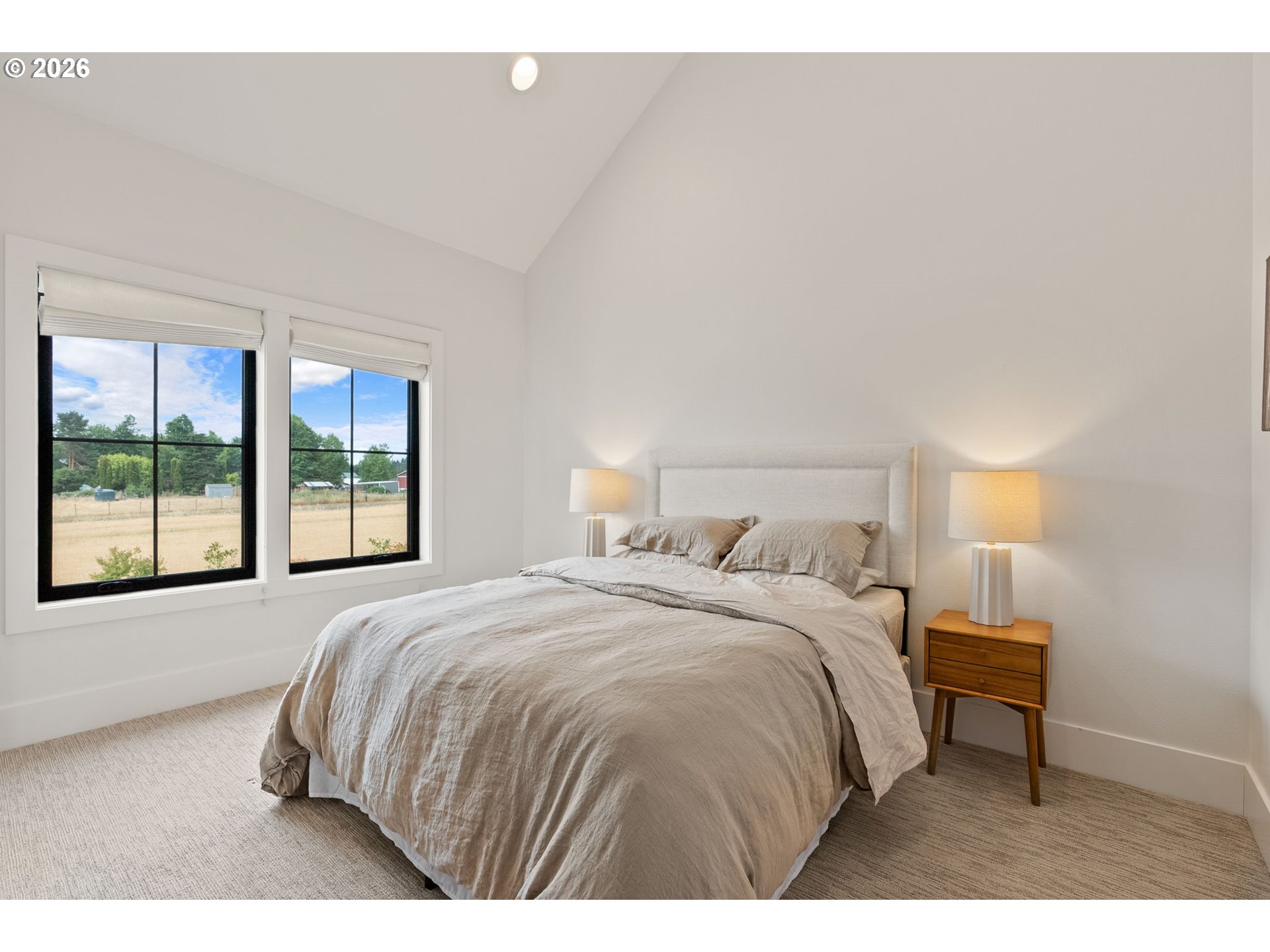 22280 Southwest Stafford Road Tualatin, OR 97062 - Photo 32 of 48 a bedroom with a bed and a large window