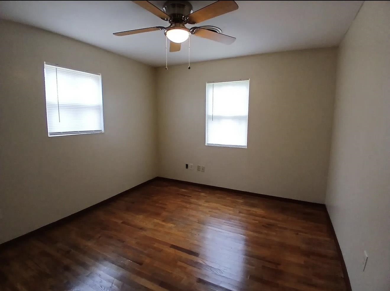 4005 Sewanee Road Memphis, TN 38109 - Photo 2 of 8 a view of an empty room with wooden floor and a window