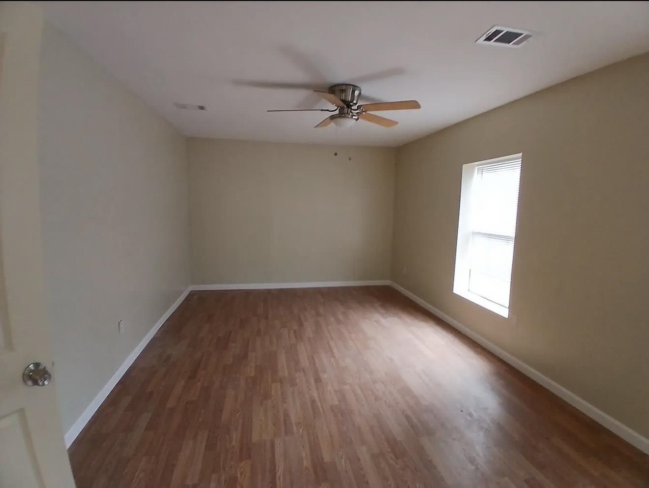4005 Sewanee Road Memphis, TN 38109 - Photo 5 of 8 wooden floor in an empty room with a window