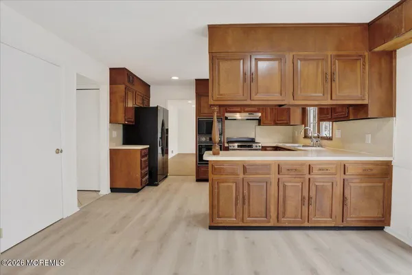 a kitchen with stainless steel appliances a refrigerator and a stove top oven