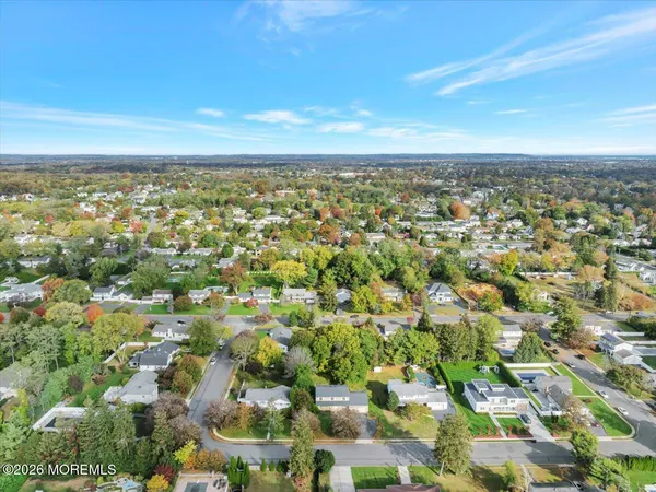 an aerial view of residential building and trees around
