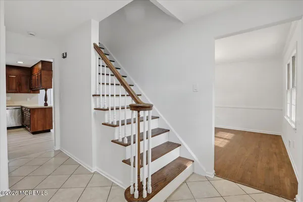 a view of entryway and hall with wooden floor