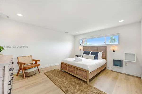 a bedroom with a bed and a chair