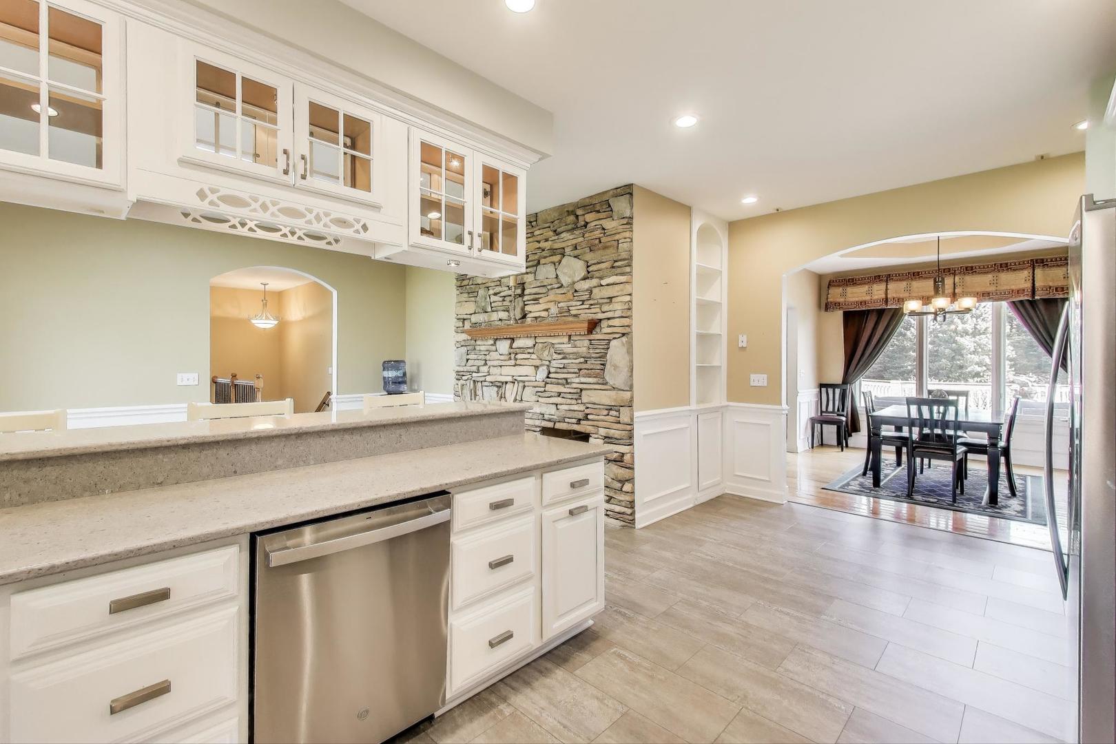 2502 Hidden Trail Spring Grove, IL 60081 - Photo 14 of 51 a kitchen with stainless steel appliances granite countertop a stove and cabinets
