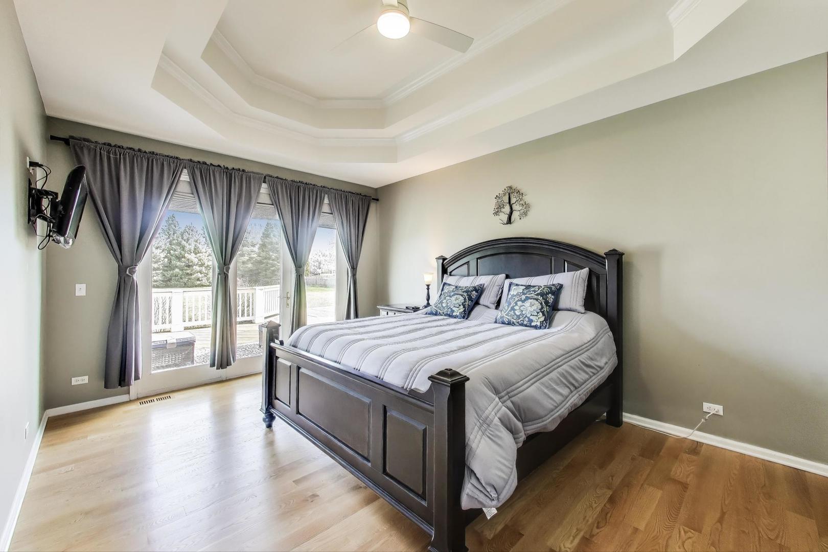 2502 Hidden Trail Spring Grove, IL 60081 - Photo 17 of 51 a bedroom with a bed and a large window with outer view