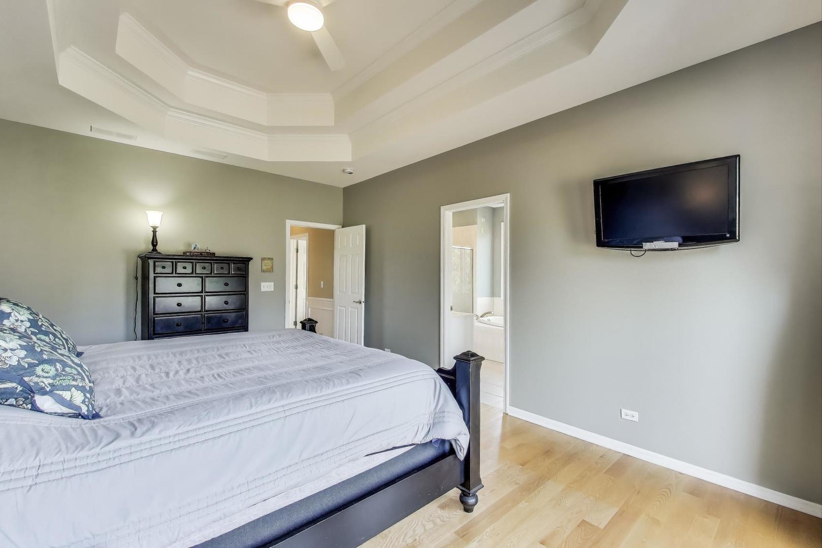 2502 Hidden Trail Spring Grove, IL 60081 - Photo 18 of 51 a bedroom with a bed and a flat screen tv