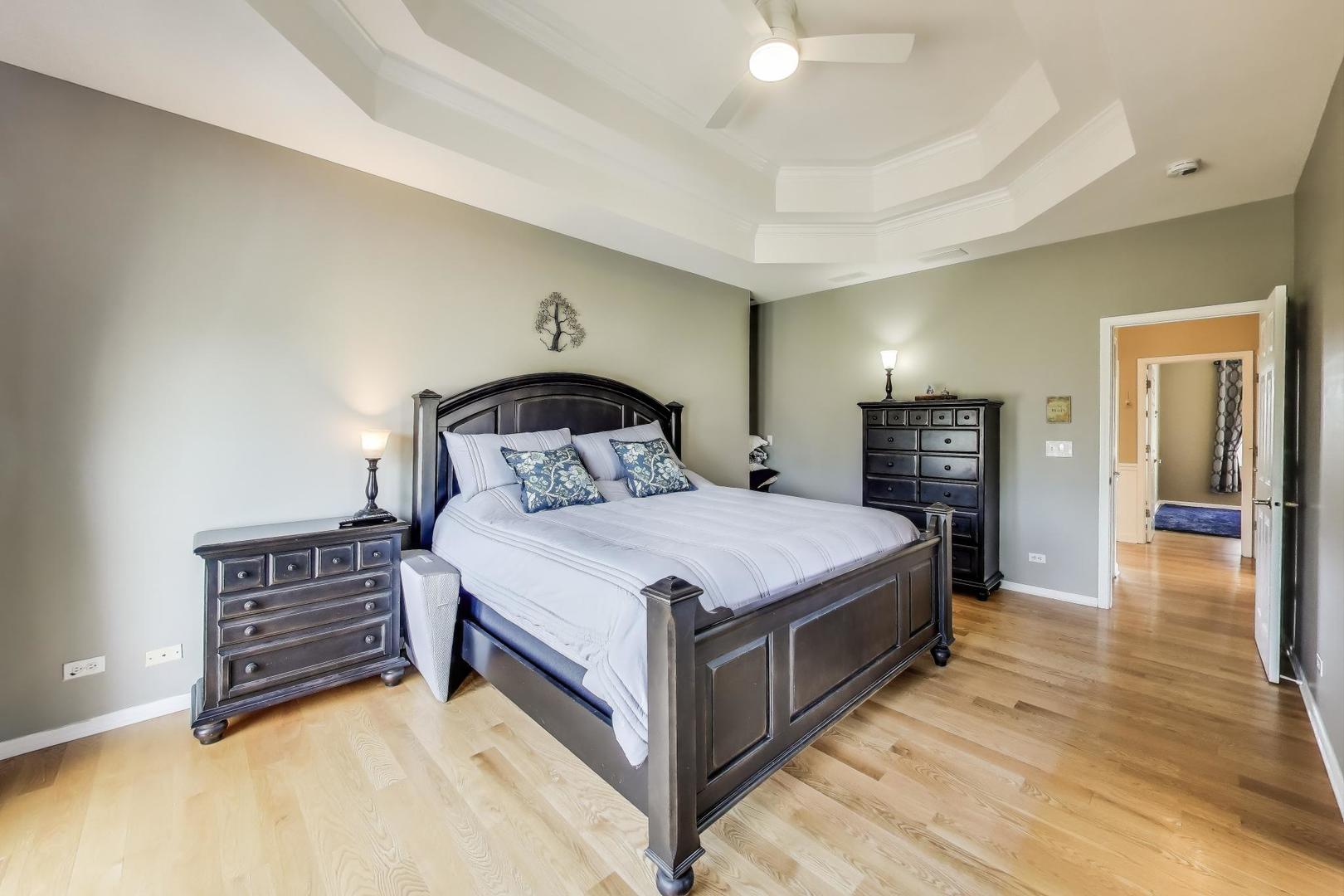 2502 Hidden Trail Spring Grove, IL 60081 - Photo 19 of 51 a bedroom with a bed and wooden floor