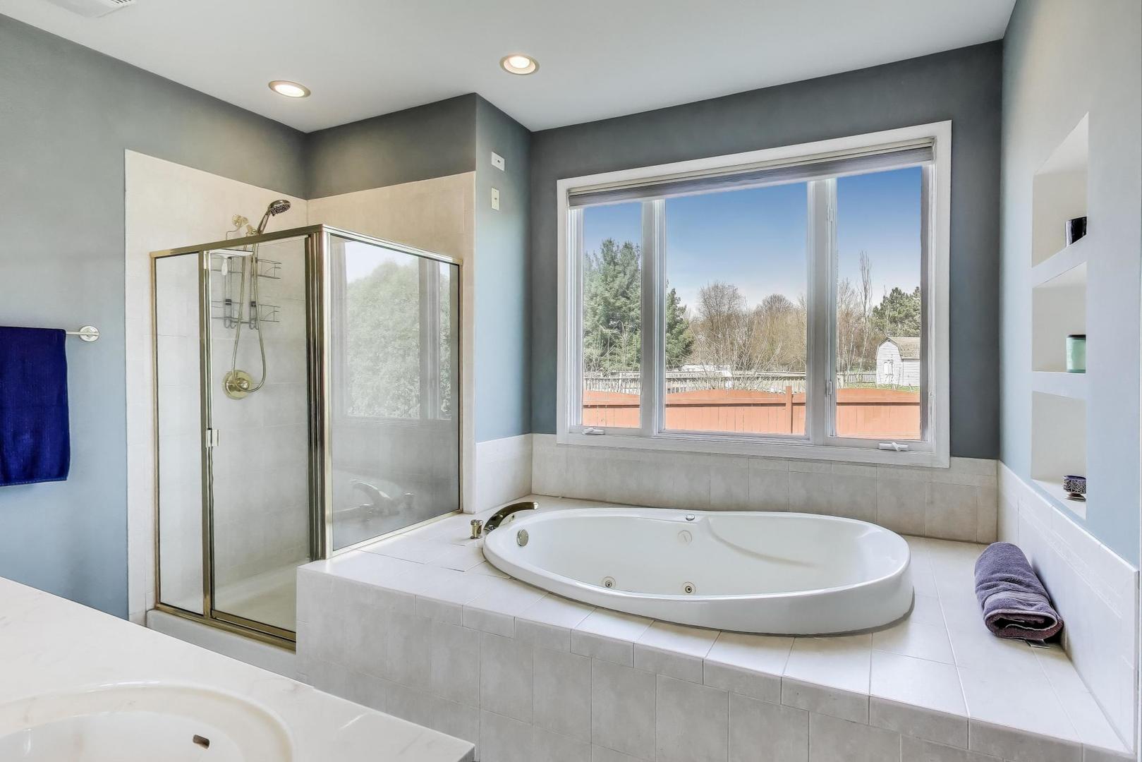 2502 Hidden Trail Spring Grove, IL 60081 - Photo 21 of 51 a bathroom with a tub a sink and a shower