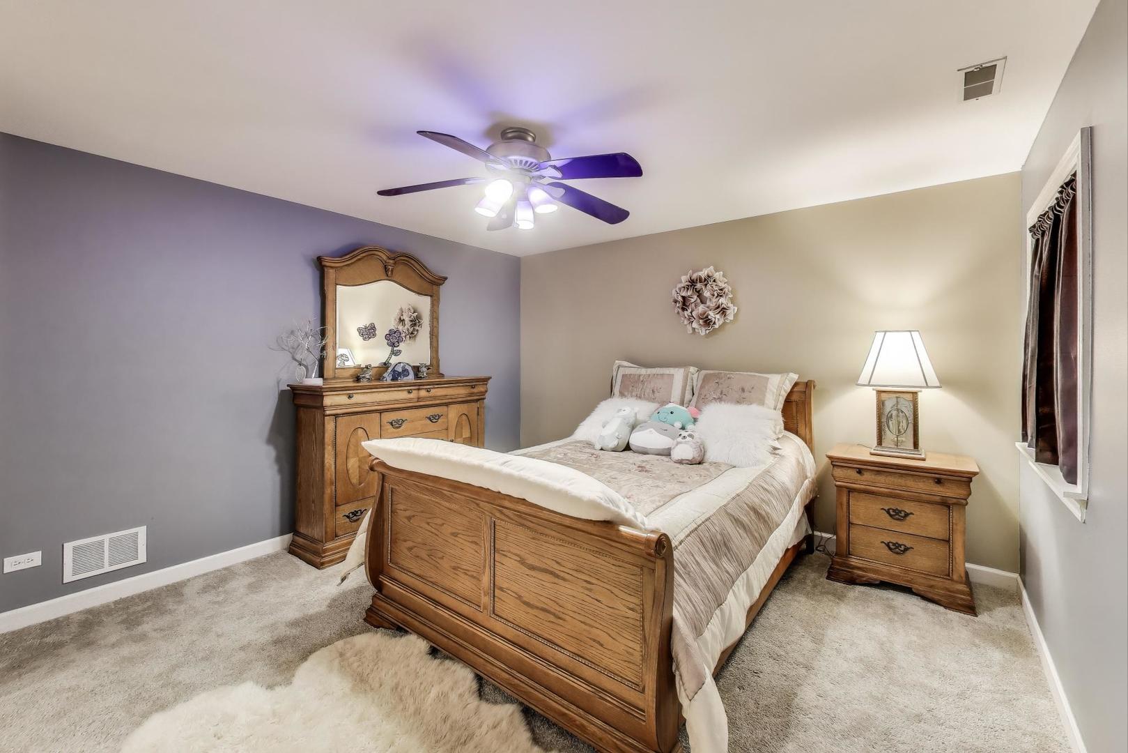 2502 Hidden Trail Spring Grove, IL 60081 - Photo 31 of 51 a bedroom with a bed and a chandelier