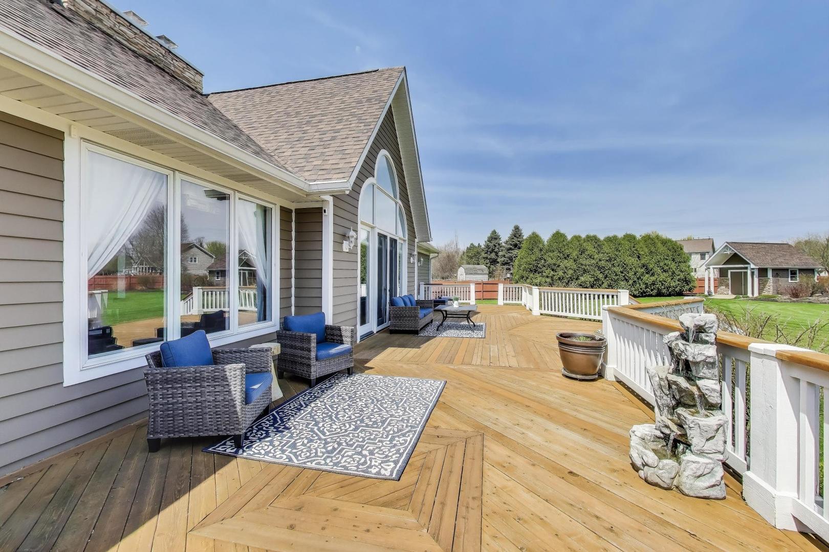 2502 Hidden Trail Spring Grove, IL 60081 - Photo 39 of 51 a view of a patio with couches chairs and wooden floor