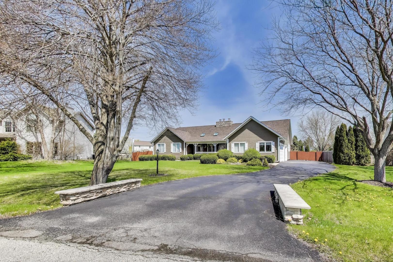 2502 Hidden Trail Spring Grove, IL 60081 - Photo 45 of 51 a front view of a house with a yard and garage