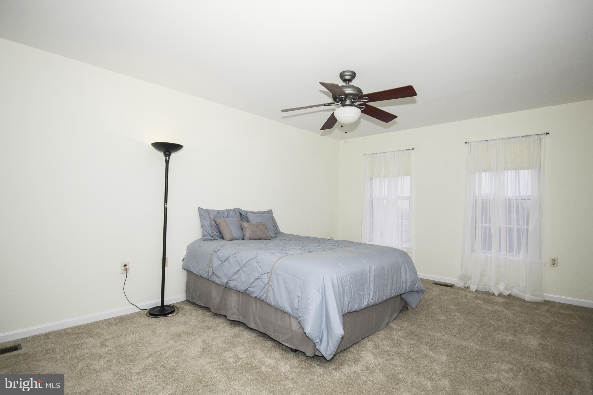 4309 Mispillion Road Baltimore, MD 21236 - Photo 12 of 29 a bedroom with a bed and a ceiling fan