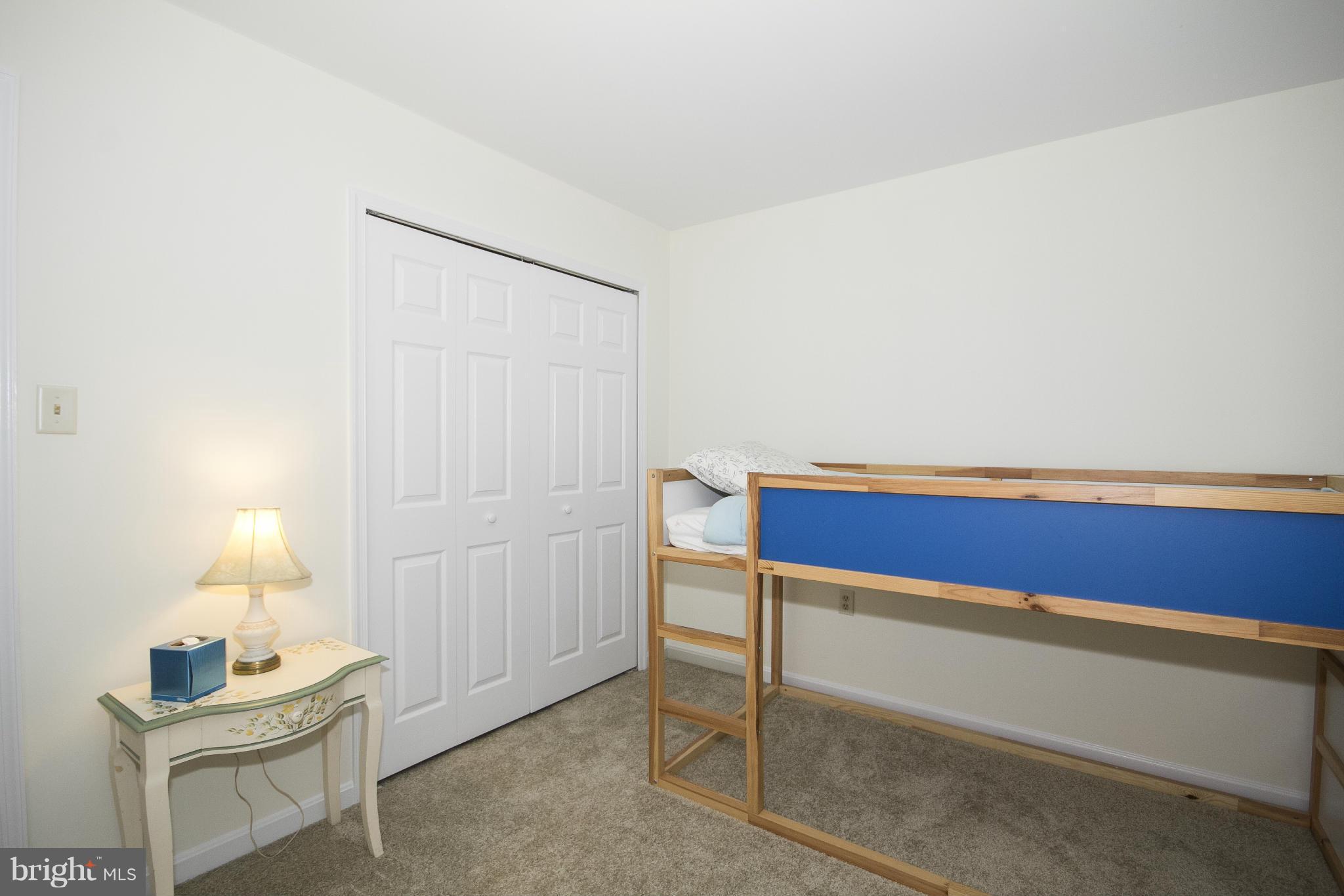 4309 Mispillion Road Baltimore, MD 21236 - Photo 20 of 29 a room with a bed and a lamp on table