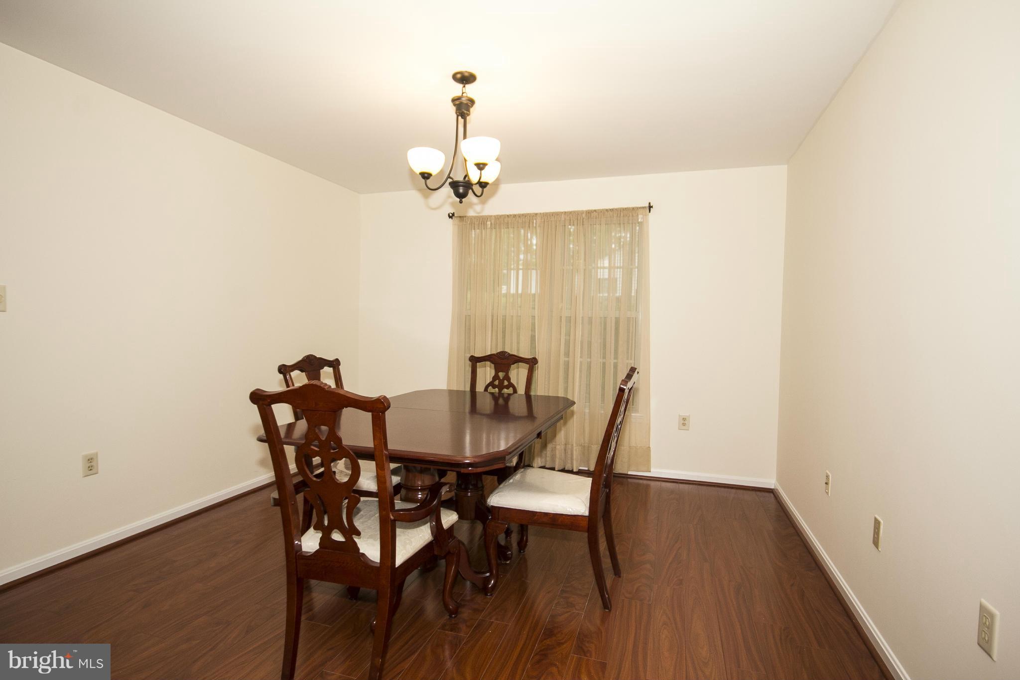 4309 Mispillion Road Baltimore, MD 21236 - Photo 4 of 29 a view of a dining room with furniture and wooden floor