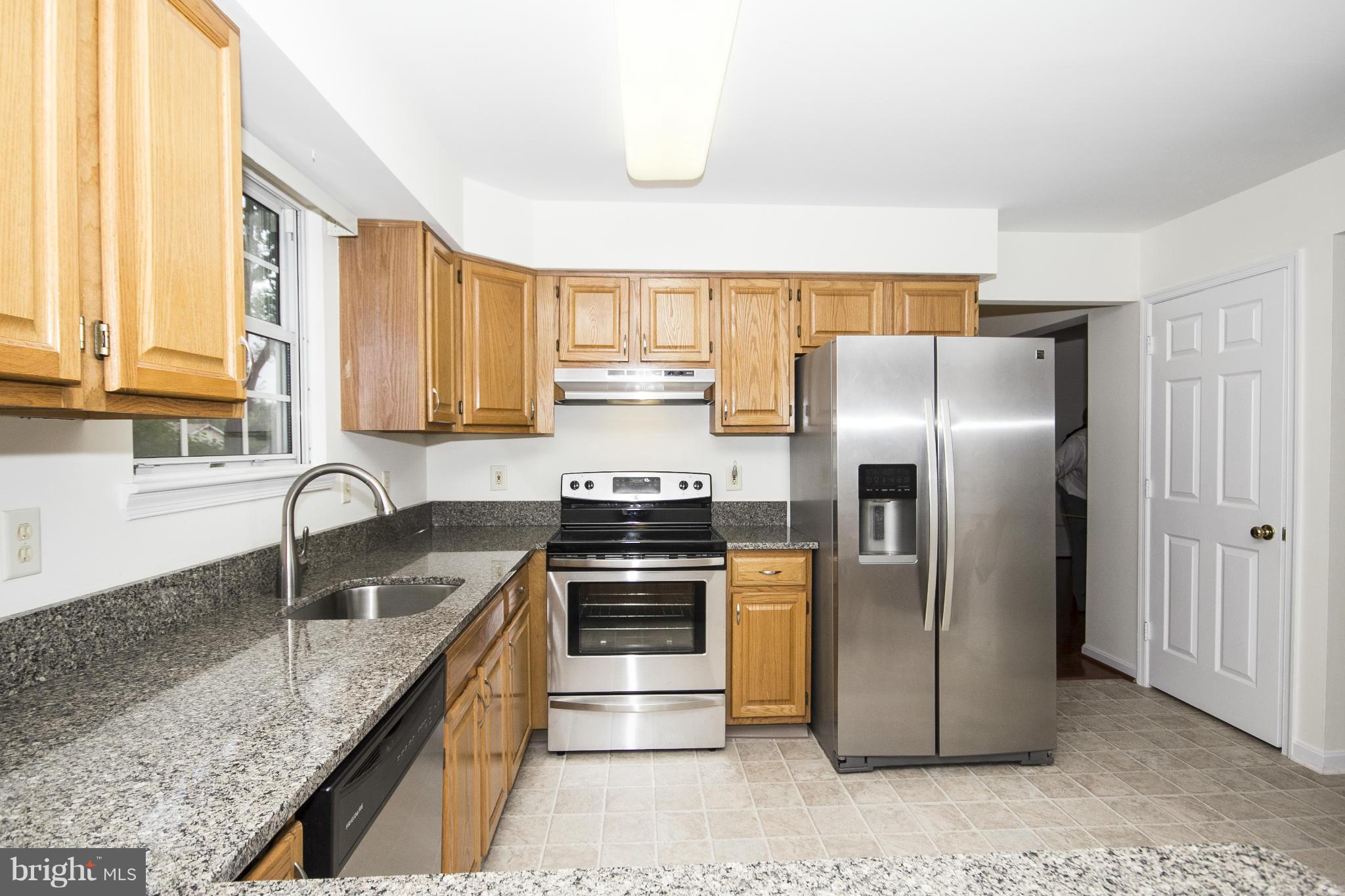 4309 Mispillion Road Baltimore, MD 21236 - Photo 10 of 29 a kitchen with granite countertop a refrigerator and a sink