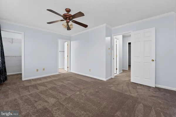 a view of an empty room with a ceiling fan