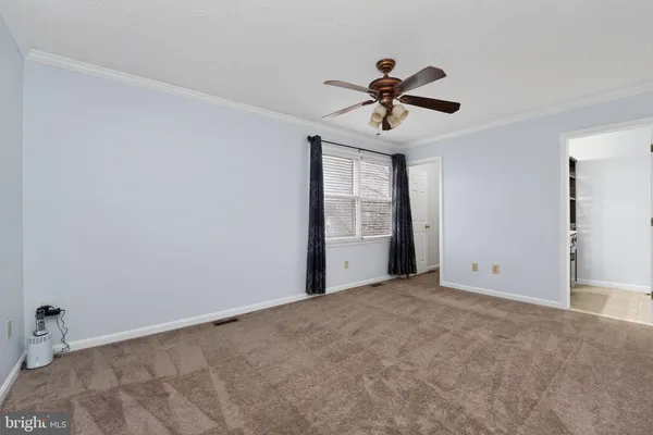 a view of a livingroom with a ceiling fan and window