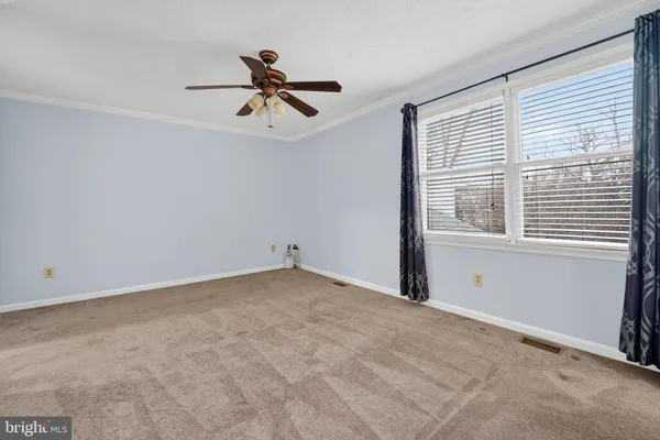 a view of a room with a ceiling fan and a window