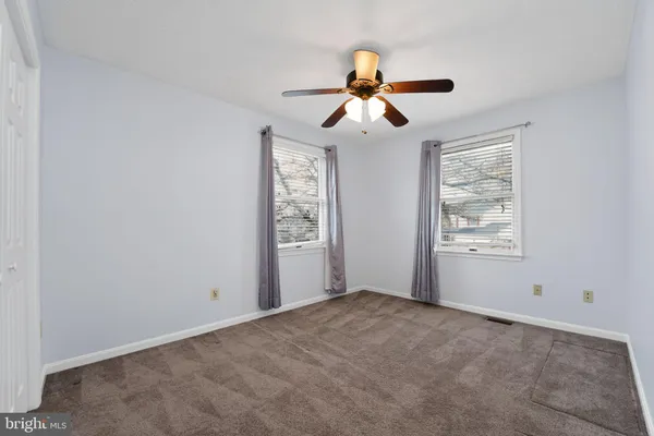 a view of room with window and ceiling fan