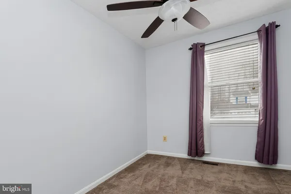 a view of room with window and ceiling fan