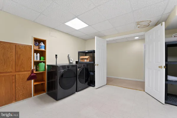 a view of a livingroom with furniture and a refrigerator