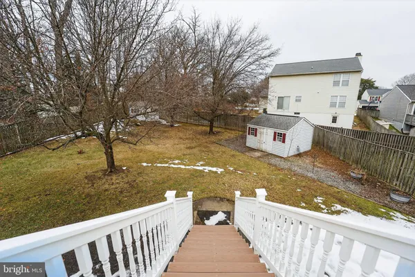a view of a wooden deck and a backyard