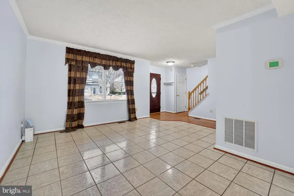 a view of an empty room and entryway