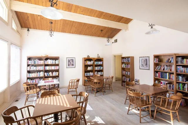 a dining room with furniture and wooden floor